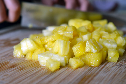 Finely chopped pineapple on a cutting board.