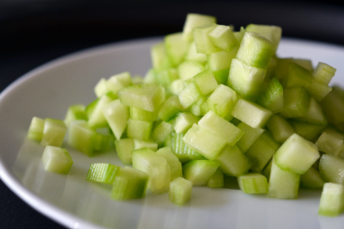 Finely chopped Persian cucumber on a plate.