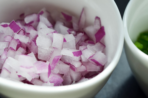 Diced red onion and jalapeño in small ramekins.