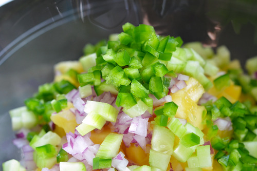 The ingredients for spicy pineapple salsa in a large bowl.
