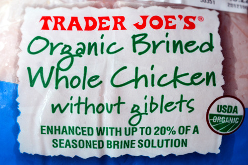 A closeup of the packaging for Trader Joe's organic brined whole chicken without giblets.