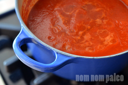 A closeup of Paleo Sriracha finished cooking in a blue saucepan.