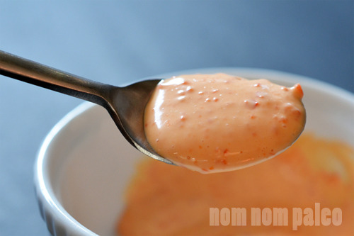 A shot of homemade sriracha mayonnaise being spooned out.
