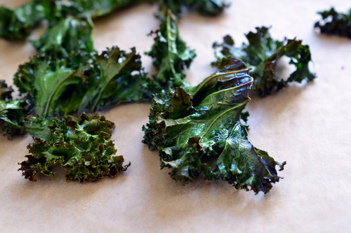 After just 12 minutes in the oven, the baked kale chips will be done! (Set your timer and keep an eye on the kale, ‘cause if the chips burns, they’ll be bitter – and so will you.)